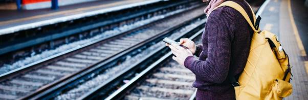 A person standing on a train platform

