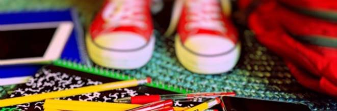 Image of pair of red trainers and stationery