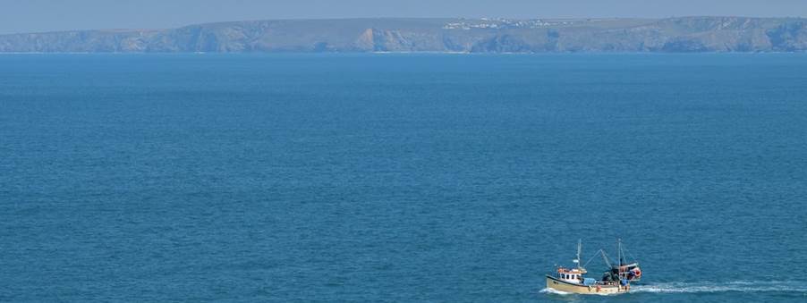 white boat on blue sea during daytime